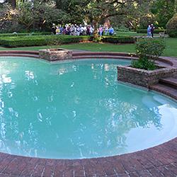 Stephanie Walsh, Lakewold's Executive Director, leads her tour group past the exquisite quatrefoil pond.